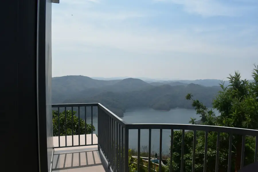Balcony view over hills and a lake